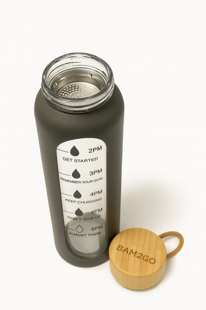 Black water bottle with time markers and a wooden cap on a white background