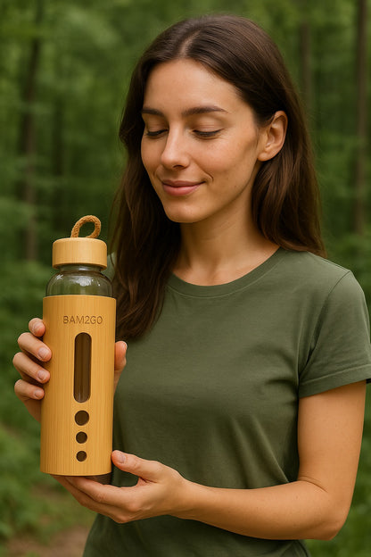 Woman holding a bamboo water bottle in a forest setting